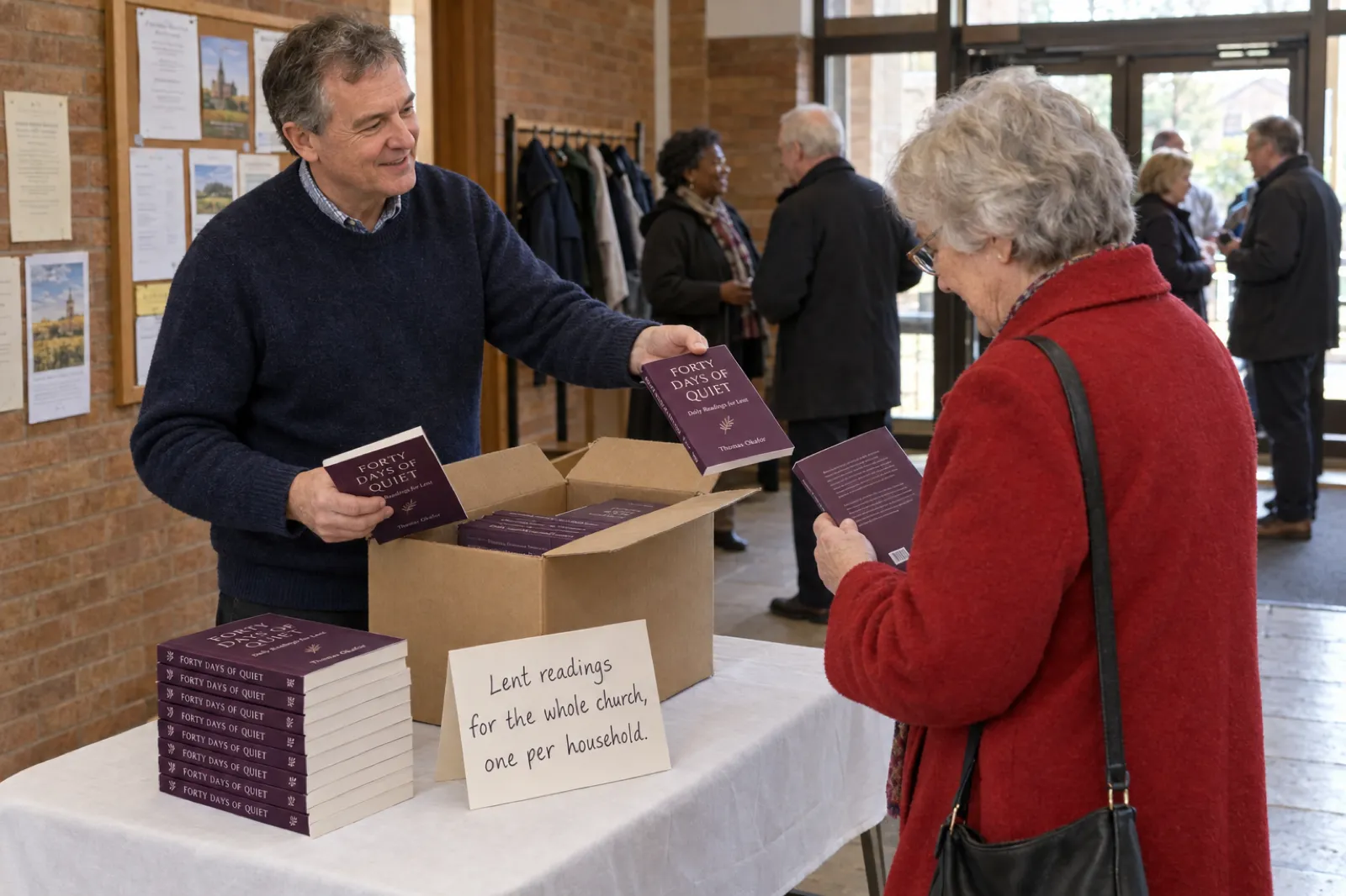 In a brick church foyer after a Sunday service, an author in a navy jumper lifts copies of Forty Days of Quiet, Daily Readings for Lent by Thomas Okafor, from a cardboard box and hands one to an older woman in a red coat, beside a stack of the books and a card reading Lent readings for the whole church, one per household
